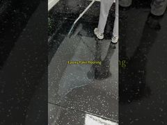 Epoxy flake floor coating handles forklift traffic without marks.