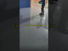 Epoxy flake floor coating hides dust and scratches in its texture.